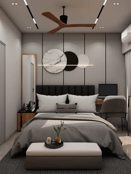 This bedroom design features a stylish workspace integrated into the layout, with a dark headboard and abstract wall art creating a sophisticated, modern vibe.