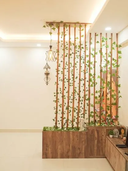A unique living room partition made of bamboo poles and decorated with green vines, creating a natural and refreshing divide. This feature adds an organic touch to the modern space.