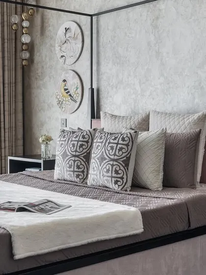 A different angle of the master bedroom with the modern four-poster bed. The textured wallpaper and minimalist decor create a space that feels both luxurious and calming.