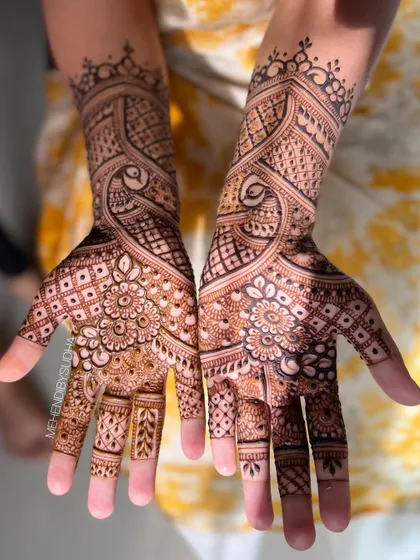 The design shown against a yellow background, highlighting the rich color of the henna.