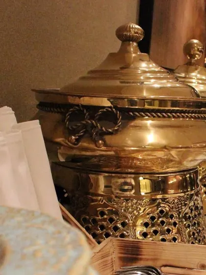 Our elegant brass chafing dishes lined up for an exclusive catering event. This serveware is a key part of our presentation for high-end Indian and Mughlai menus.