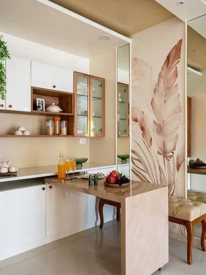 This design features a clever movable breakfast table that can be tucked away when not in use. The white and wood cabinets create a light and airy feel.