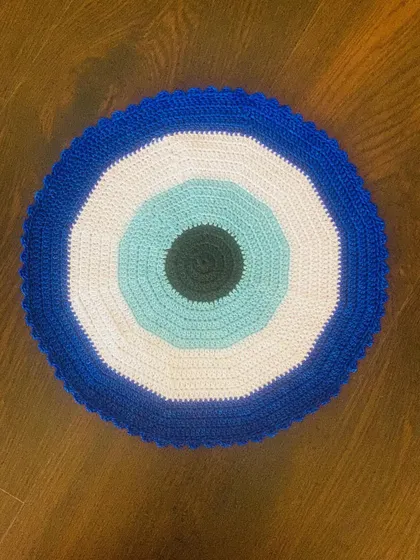 Here is my take on the trendy Evil Eye design, crocheted into a bold placemat. It's a modern and protective symbol that adds a unique and stylish touch to your living space.