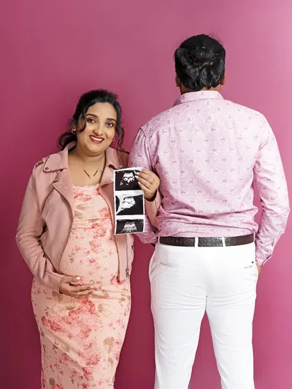 Sharing the very first picture of their baby. The mom-to-be holds up the ultrasound scan in this sweet and personal announcement photo.