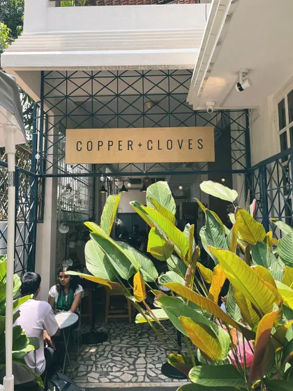 Our entrance on a sunny day, surrounded by lush green plants. I wanted the cafe to feel like an oasis in the city, a welcoming and refreshing space from the moment you arrive.