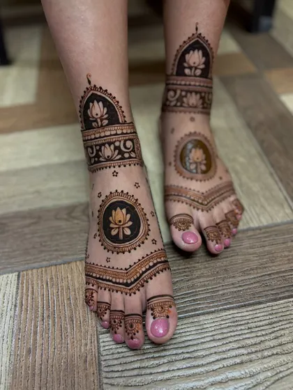 A beautiful feet design with a central lotus mandala and a patterned ankle band.