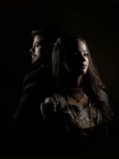 A moody and dramatic sangeet portrait using low-key lighting to create a sense of intimacy and artistry. This style is for couples who want their pre-wedding photos to feel like a piece of fine art.