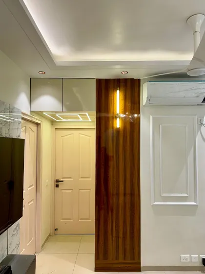 To maximize storage, I often add lofts above the main door frames. This unit has a high-gloss finish and is lit with a profile light.
