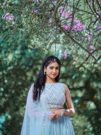 A full-length shot showing the entire lehenga against the beautiful park background.