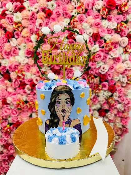 The trending "blow-up" cake. A smaller mini-cake is placed in front of a larger cake, creating a fun visual illusion that's perfect for photos.