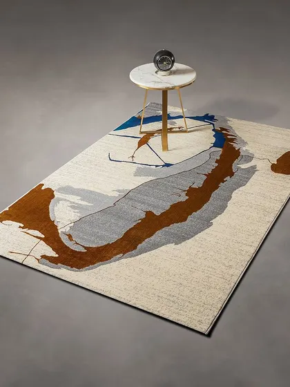This ultra-luxe rug features a modern abstract design in earthy tones of brown, grey, and blue. It's like a piece of art for your floor, perfect for grounding a contemporary living room.