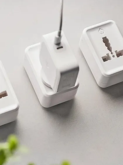 This shot for Phynart shows their smart plugs in a lifestyle context. The flat lay with a laptop and plant makes the technology feel like a natural part of a modern, organized workspace.