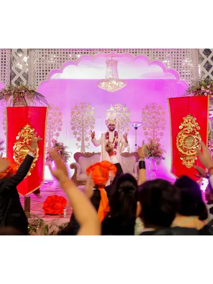 The groom's grand entrance, with the crowd cheering him on.