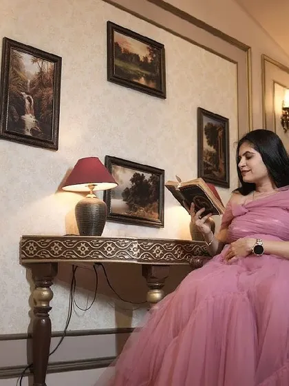 A client looking like a princess in a pink ball gown for her maternity photoshoot.