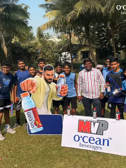 The boys' team posing with our sponsor's banner at the Winter Basketball League. Building a community involves everyone, including our partners who support youth sports.