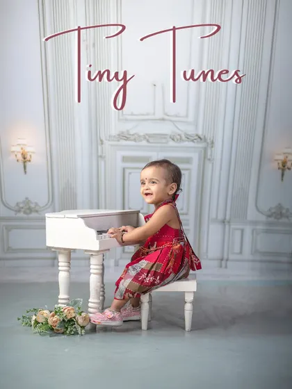 Tiny tunes from a mini maestro. This little girl is creating her own melody, a perfect picture of concentration and cuteness at the miniature piano.
