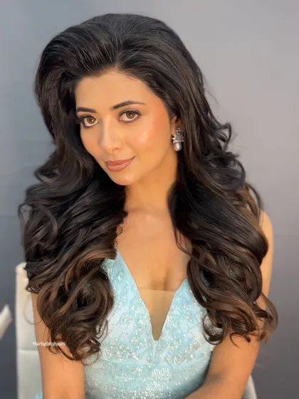 A softer, smiling shot of the model, showing how this hairstyle can be both dramatic and beautifully feminine.