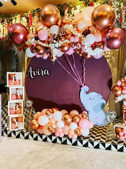 Another angle of the rose gold and pink elephant-themed first birthday, showing the "BABY" blocks and custom backdrop.