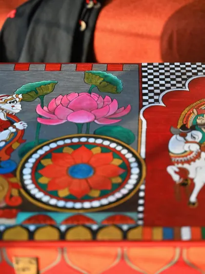 A focused shot on the lotus and Yali motifs, bringing the fine details and vibrant colors to the forefront. Each brushstroke is a deliberate part of the storytelling process.