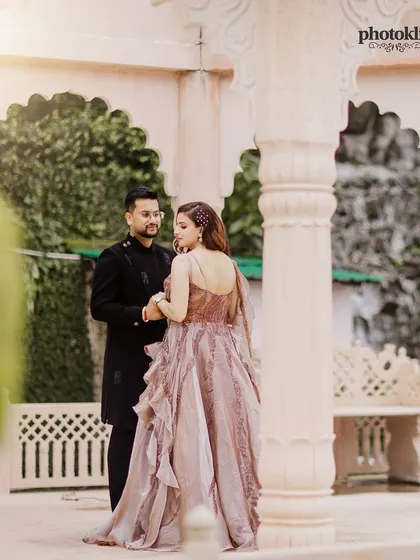 A beautifully composed shot of the couple at LP Vilas, Dehradun, using the venue's architecture to frame their portrait. This is a great example of our location-based pre-wedding photography.