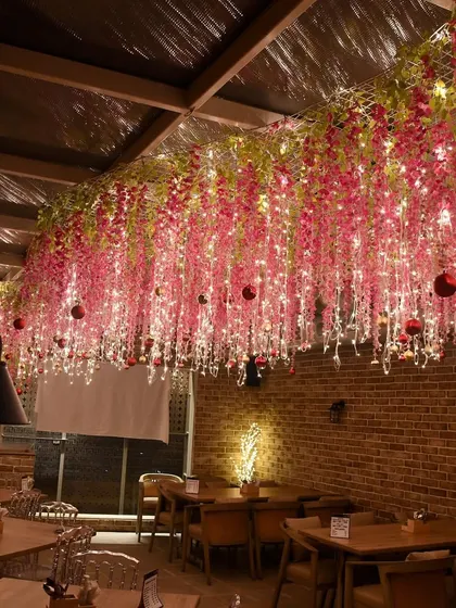 Another shot of the magical pink floral ceiling, showing how the fairy lights and hanging flowers transform the entire restaurant space.