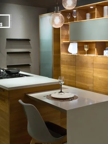 For smaller spaces, a pull-out dining table integrated into the kitchen island is a brilliant solution. This design combines warm wood cabinetry with a clean white countertop for a timeless look.