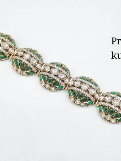 A premium quality Kundan bracelet with a beautiful design featuring green stones.