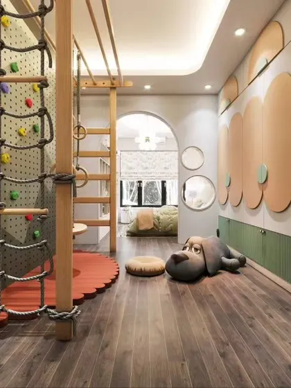 This kid's room is a dream for active children, featuring a built-in climbing wall, monkey bars, and a rope ladder. The design safely integrates a play gym into the bedroom space.