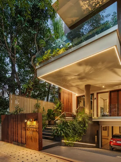 The entrance of Kanasu is softened by lush landscaping, with integrated lighting that makes the approach feel welcoming and magical at night.