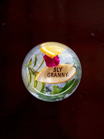 A refreshing gin-based cocktail, beautifully branded and garnished with edible flowers. It’s almost too pretty to drink. Almost.