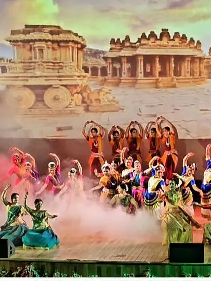 A wide-angle shot of the 'Matrabhoomi' production, showing over 30 dancers on stage. The use of smoke and a historical backdrop adds to the grandeur of the performance.