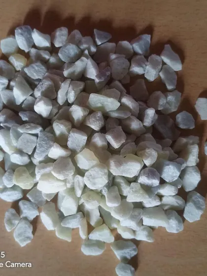 A pile of pale green and white unpolished stone chips.