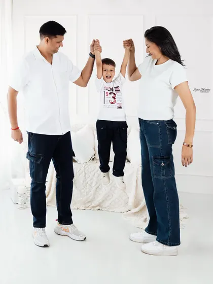A fun and energetic family moment! Lifting up the little one always brings out the biggest smiles and creates a photo full of life and happiness.