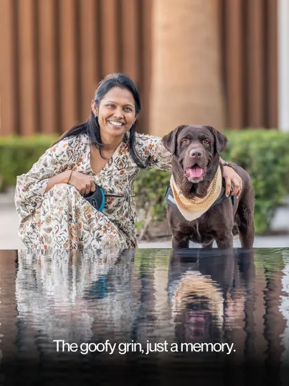 A woman and her dog by the water, a reminder that the goofy grin will one day be just a memory.