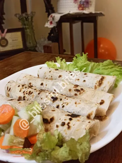 Another shot of the Smokey Chicken Rolls, highlighting the fresh ingredients and homemade quality of this popular snack item.