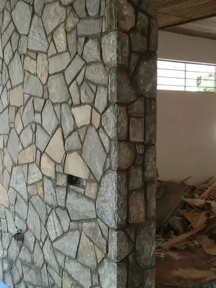 A stone-clad pillar during a renovation project. The natural stone texture provides a great contrast to smooth painted walls.