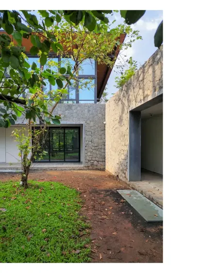 A view of the House in a Grove, just as it is being completed. The architecture becomes a bystander, a partner to the grove, pushing the inhabitants to use the outdoors as their primary living space.