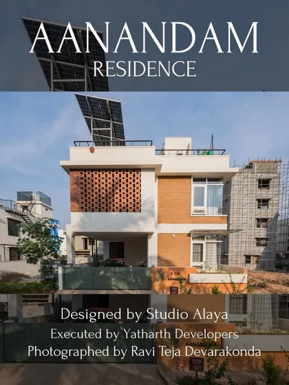 The Aanandam Residence, a project featuring a prominent brick jaali screen on the first floor for privacy and ventilation. The rooftop is equipped with solar panels, reflecting the home's green building principles.