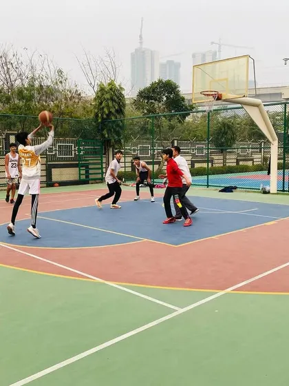 A player takes a jump shot, focusing on form and follow-through.