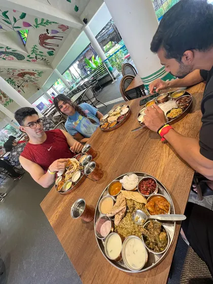 Enjoying a large thali with friends. My coaching teaches you how to handle social situations and big meals so you can live your life fully while staying committed to your long-term health.