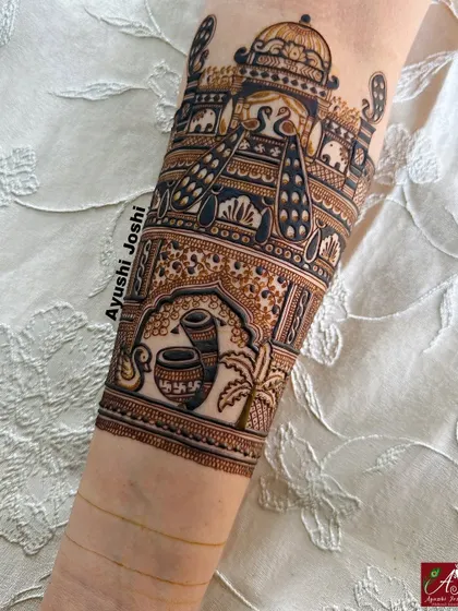 A bridal arm band design featuring traditional wedding elements like the kalash and dhol, set within a royal palace scene.