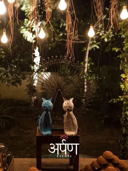 Creating the right mood is essential. The combination of warm string lights and unique decorative elements, like these cat figurines, added a whimsical touch to the sophisticated outdoor bar area.