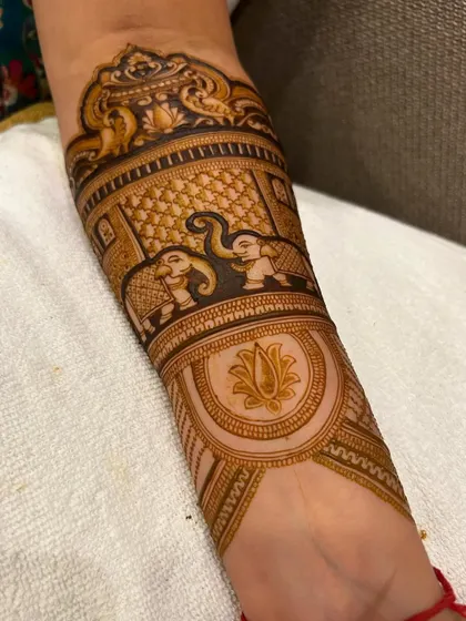A side view of the royal elephant leg mehndi. You can see the detail in the elephants and the lotus motif, all part of a larger bridal piece.