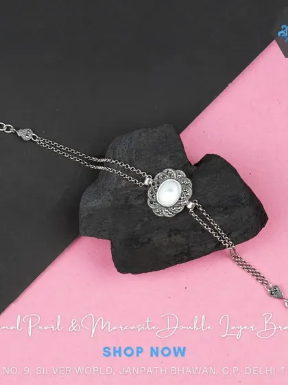 A unique double-layer bracelet with a central mother-of-pearl and marcasite motif. This design adds depth and interest to your wrist.