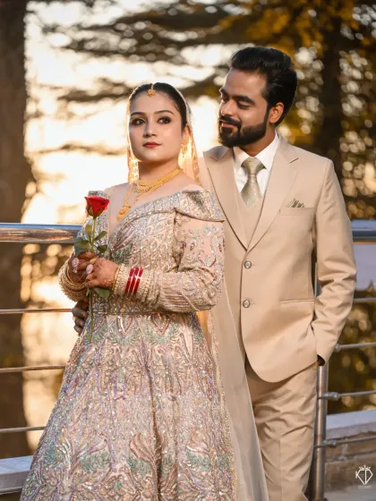 A beautiful golden hour portrait. The warm light illuminates the bride's intricate gown and the loving look from her partner.