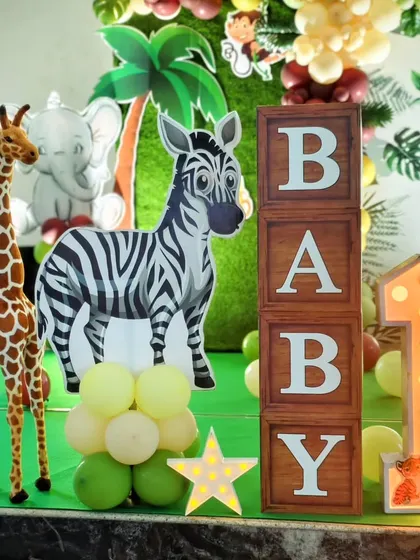 A detail shot showing the 'BABY' blocks, a large '1' marquee light, and a zebra cutout.