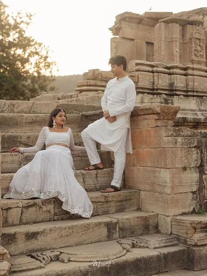 Posed against ancient architecture, this couple's portrait session captures a sense of timeless love. The golden hour light adds a warm, romantic glow to their story.