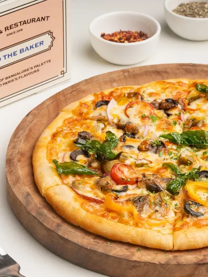 The Farmer's House Veg Pizza from another angle, showing the colorful medley of fresh toppings.