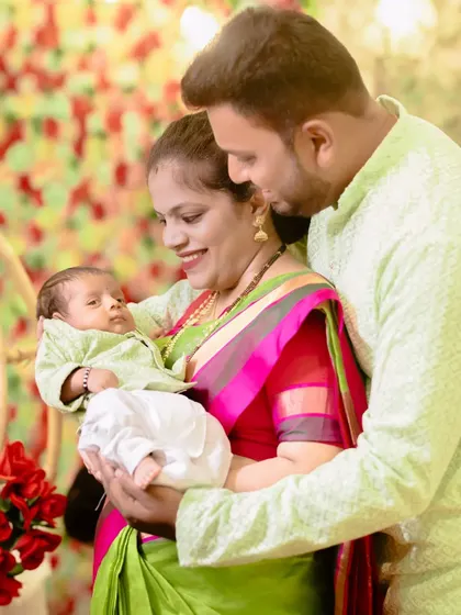 New parents lovingly gaze at their baby during what appears to be a traditional family ceremony.