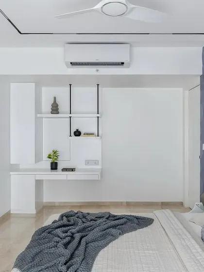 The functional workspace and TV area in the lavender bedroom, demonstrating how practicality is integrated into the sophisticated design.